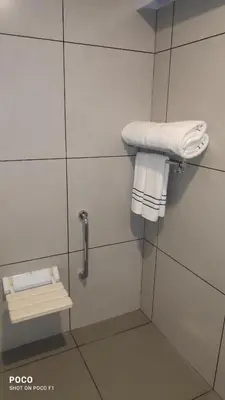 a bathroom with white towels on a wall at Emperor-Hotel Rachana Continental Pvt Ltd in Kizhake Chālakudi