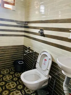 a bathroom with a toilet and a sink at DOLPHIN ENCLAVE SERVICE STUDIO APARTMENTS in Kalpetta