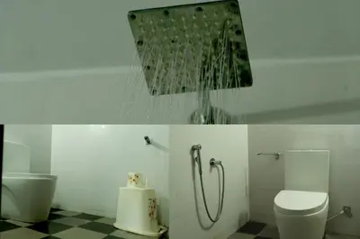 a bathroom with a shower and a toilet at NARMADA POOl VILLA in Angādipuram