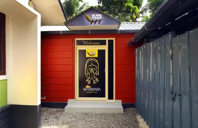 a red shed with a poster on the door at NARMADA POOl VILLA in Angādipuram