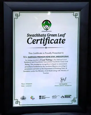 a framed sign for a green leaf centricitute at NARMADA POOl VILLA in Angādipuram