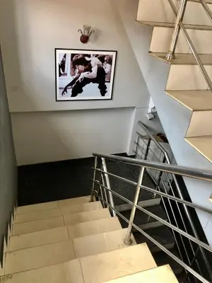 a staircase with a picture hanging on the wall at New AS Tourist Home Aluva in Cochin