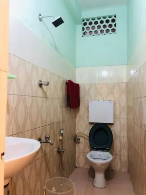 a bathroom with a toilet and a sink at New AS Tourist Home Aluva in Cochin