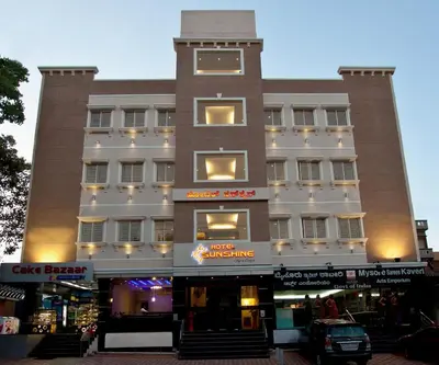 a large building with a clock tower on top of it at Hotel Sunshine in Mysore
