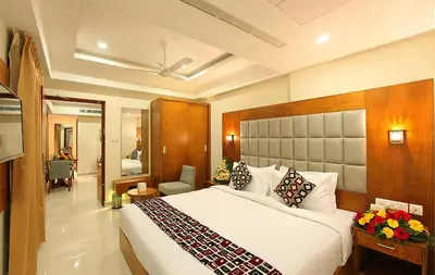 a bedroom with a large bed in a room at Lumbini Supreme in Trichūr
