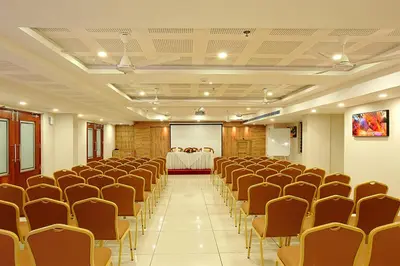 a conference room with chairs and a table in the background at Lumbini Supreme in Trichūr