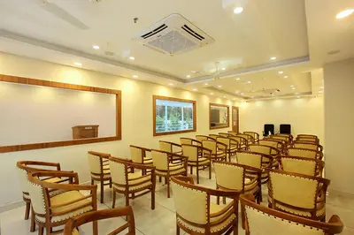 a room with a bunch of chairs and a table at Lumbini Supreme in Trichūr