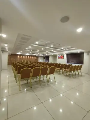 a room with rows of chairs in a hall at Lumbini Supreme in Trichūr