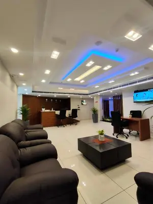 a large lobby with couches and a flat screen tv at Lumbini Supreme in Trichūr