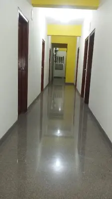 an empty hallway of a building with a long floor at Star Residency in Mysore