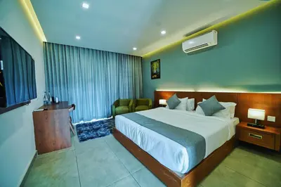 a hotel room with a bed and a window at Jungle Bay Resorts & Spa in Wayanad