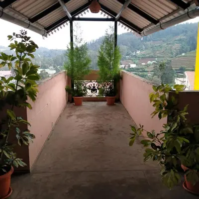 a balcony with potted plants and a view at HAVEN COTTAGE in Ooty