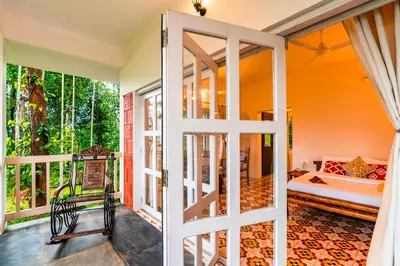 an open door to a room with a balcony at Zostel Homes Wayanad, Karapuzha in Wayanad