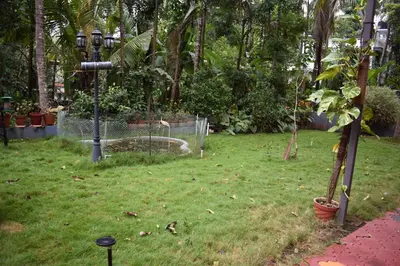 a yard with a park with a fence and a street light at Ben's Villa Kannur ! in Kannur