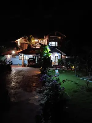 a house at night with a sign in front of it at Ben's Villa Kannur ! in Kannur