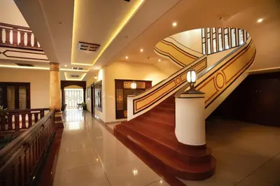 a spiral staircase in a building with a lobby at Wayanad Mace Mansion in Kenichira