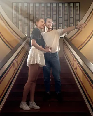 a man and a woman standing on a staircase at Wayanad Mace Mansion in Kenichira