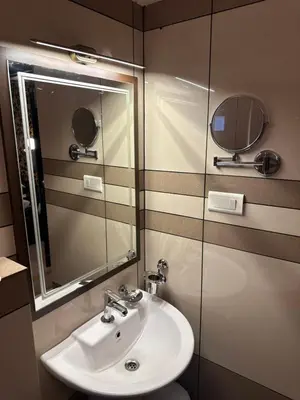 a bathroom with a sink and a mirror at GD International Redfort in Nilambūr