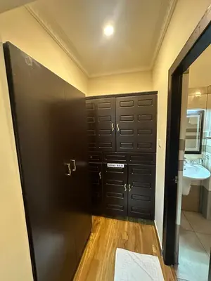 a bathroom with black doors and a sink at GD International Redfort in Nilambūr