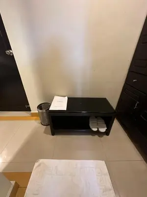 a small black table with two white towels on it at GD International Redfort in Nilambūr