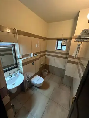 a bathroom with a toilet and a sink at GD International Redfort in Nilambūr