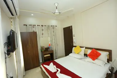 a bedroom with a bed with colorful pillows at Hotel Innate Inn in Alwaye