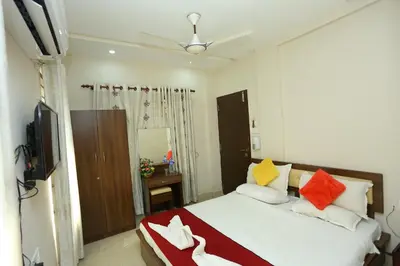 a bedroom with a bed with colorful pillows at Hotel Innate Inn in Alwaye