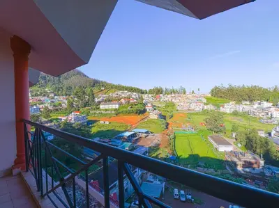a balcony with a view of a city at The Byke Sunshine Grand in Ooty