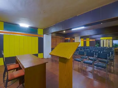 a room with a bunch of chairs and a table at The Byke Sunshine Grand in Ooty