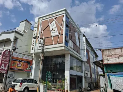a building on the side of a street at OYO Flagship 8281 Aj Palace in Mysore