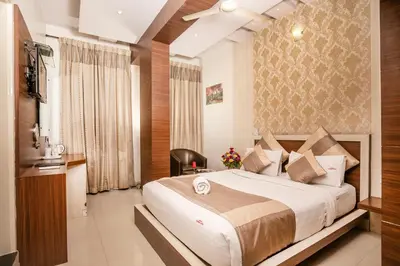 a bedroom with a large bed in a room at Aishwarya Suites in Mysore