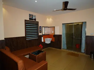 a living room with a couch and a shower at ABUDHABI RESIDENCY in Palakkad