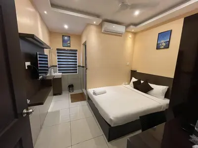 a small bedroom with a bed and a bathroom at ABUDHABI RESIDENCY in Palakkad