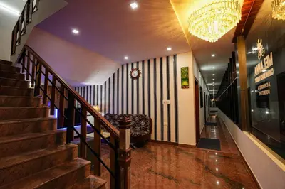 a staircase in a building with a chandelier at Melanna Cherai Beach in Cherai Beach