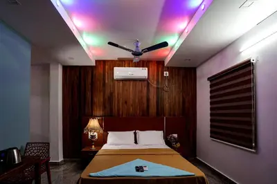 a bedroom with a bed with a ceiling fan at Melanna Cherai Beach in Cherai Beach