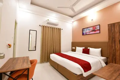 a bedroom with a large bed and a desk in it at Xcel Luxury Hotel Apartments-Home Living Redefined in Mysore