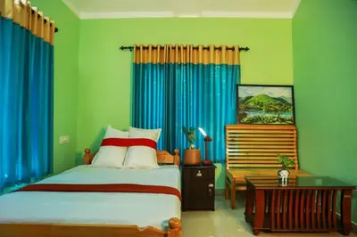 a bedroom with a bed and blue curtains at Puzhayoram home stay, Palakkuli, Mananthavadi wayanad kerala in Mananthavady