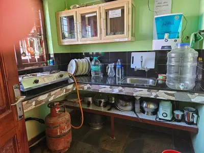 a kitchen with a counter top with a sink and a counter at Puzhayoram home stay, Palakkuli, Mananthavadi wayanad kerala in Mananthavady