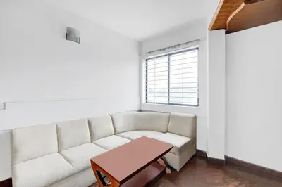 a living room with a couch and a table at Super Townhouse Mysore City Centre Formerly Hotel Mahendra in Mysore
