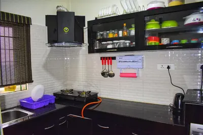 a kitchen with a sink and a counter with utensils at S ELLA Residency in Kotagiri