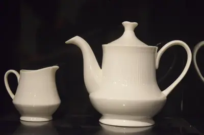 two white vases sitting on top of a table at S ELLA Residency in Kotagiri