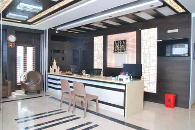 a bar with chairs and a desk in a room at Mysore Royale in Mysore