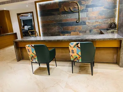 two chairs sitting at a bar in a room at MothiMahal Residency Thrissur in Trichūr