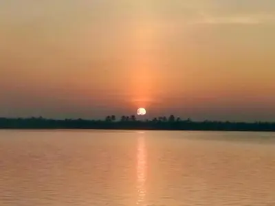 a sunset over a body of water at Kalamana Serene in Chāvakkād