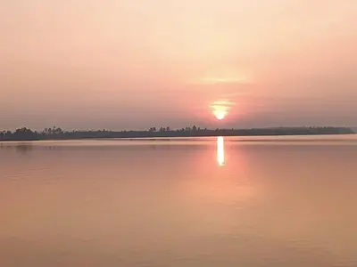 a sunset over a large body of water at Kalamana Serene in Chāvakkād