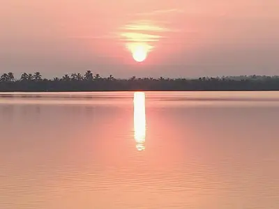 a sunset over a body of water at Kalamana Serene in Chāvakkād