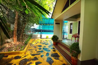 a hallway with a stone floor in a building at NARMADA POOL VILLA (KAVERI) in Perintalmanna