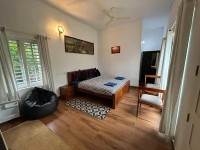 a living room with a couch and a table at Silver Oak By Exuberance Stays (Independent Holiday Home) in Wayanad
