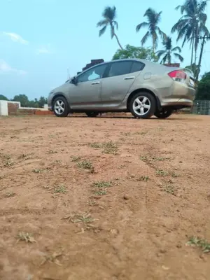 a car parked in a dirt field with palm trees at NARAYANALAYAM-Vintage Retreat-Homestay & Rest'Inn in Kannur