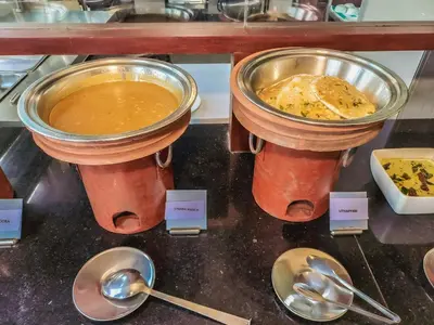 two bowls of food and spoons on a counter at The Wave Lakeview Resort & Spa in Wayanad